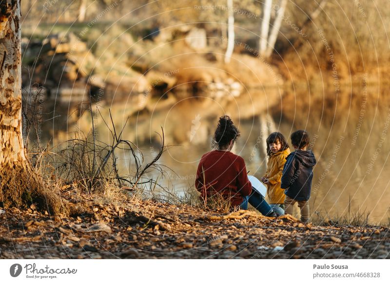 Mother with children on the river motherhood Child childhood three people Family & Relations Nature holiday travel Authentic Autumn Happiness Parents Cute