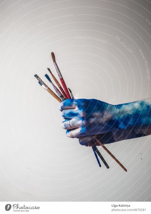 Hands with blue paint holding paintbrushes Paint Art Dye Painting (action, work) Colour Draw Painter Creativity Painting and drawing (object)