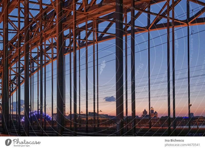 Sunset in Cologne photographed through the Hohenzollern Bridge. Detail Sunlight sunset Twilight Sky Clouds Evening Dusk Silhouette Exterior shot Colour photo