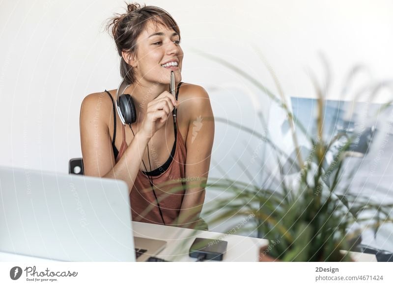 Young woman working on laptop in her office entrepreneur businesswoman female indoor technology home one person online adult computer home office sitting