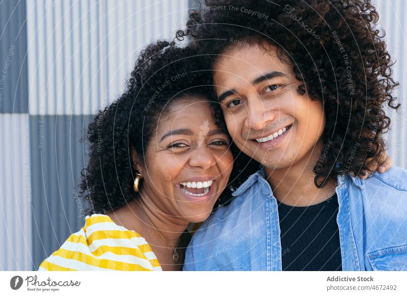 Ethnic man with overjoyed girlfriend on street couple happy love excited greeting cheerful beloved boyfriend positive tender close fondness affection unity