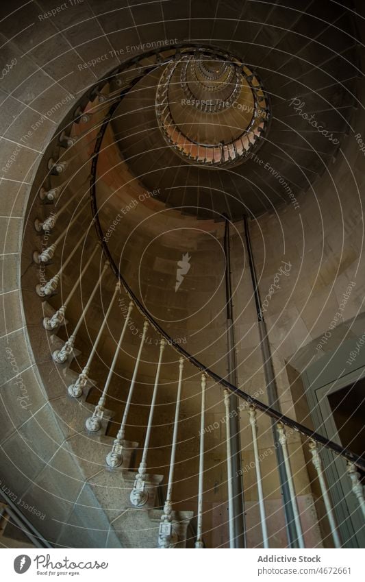 Long spiral staircase in tower stairway step design style storey old fashioned vintage railing retro interior long spacious light minimal creative france metal