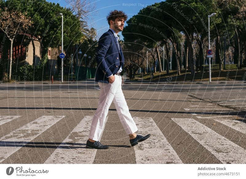 Stylish Hispanic man crossing road crosswalk pedestrian style city street elegant urban zebra appearance male confident hispanic handsome beard trendy mustache