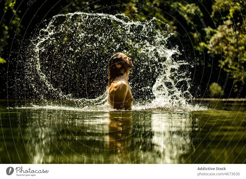 Male tourist enjoying vacation in lake water man flip splash splatter river recreation resort traveler long hair beard pond female summer journey rest nature