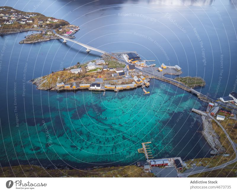 Islands with buildings near sea island archipelago house water road town coast waterfront bridge residential Reine norway lofoten calm scenic clear grassy