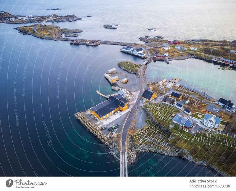 Islands with buildings near sea island archipelago house water road town coast waterfront bridge residential Reine norway lofoten calm scenic clear grassy