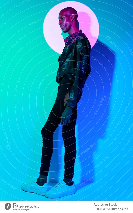 Fashionable black man in studio style fashion light trendy modern design illuminate outfit attire appearance confident glow african american ethnic guy colorful