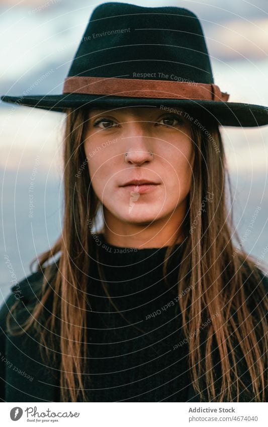 Peaceful woman in hat on shore peaceful tranquil sea water style embankment nature harmony trip tourism coast beach female seaside trendy seashore ripple