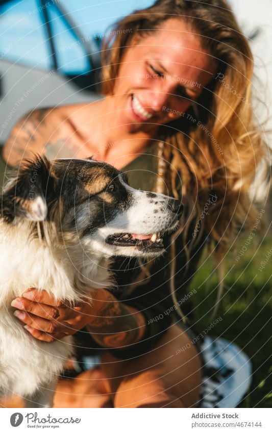 Smiling woman caressing Australian Shepherd dog owner australian shepherd pet animal street hug breed purebred canine embrace companion positive adorable friend