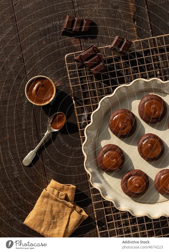 Salted caramel chocolate cookies on ceramic plate salted caramel bakery sauce sweet food biscuit top view rustic confectionery nobody biscuits wooden baked