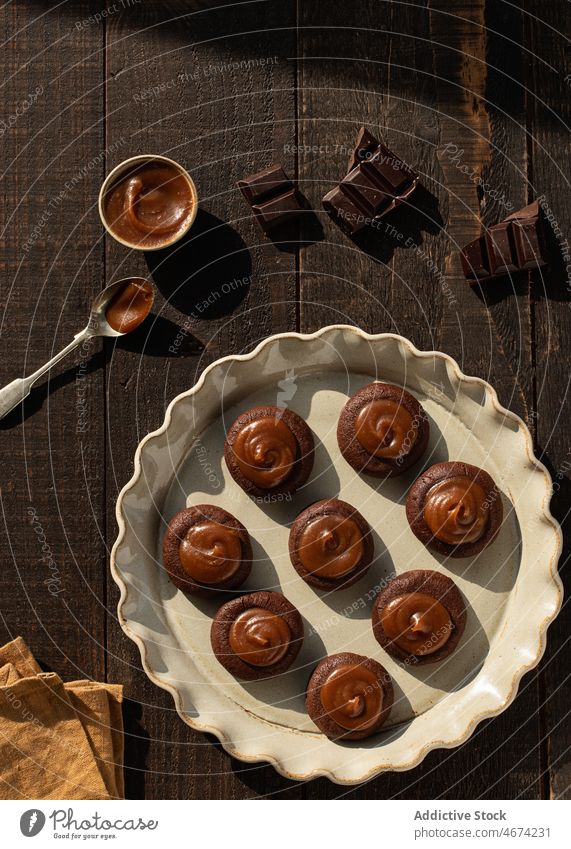 Salted caramel chocolate cookies on ceramic plate salted caramel bakery sauce sweet food biscuit top view rustic confectionery nobody biscuits wooden baked