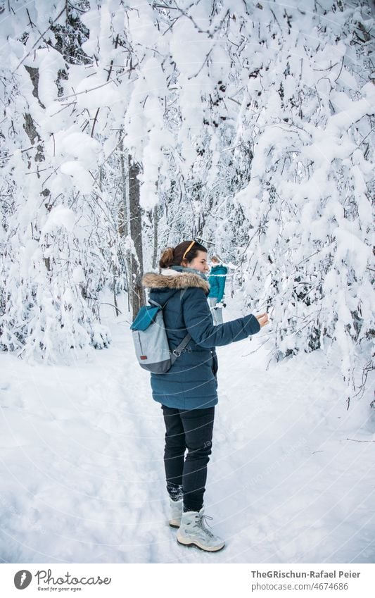 Woman walking in snow in forest Snow Tree snow-covered trees To go for a walk Cold Winter White Frozen snowy Switzerland