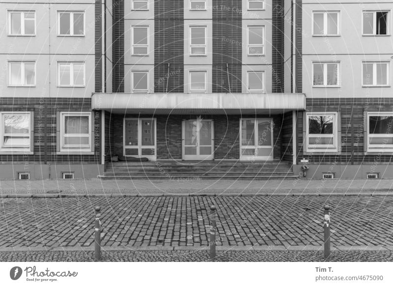 a homeless man sleeps in the entrance of a prefabricated building in Berlin Mitte Homeless homeless person Middle Prefab construction Poverty Town Exterior shot