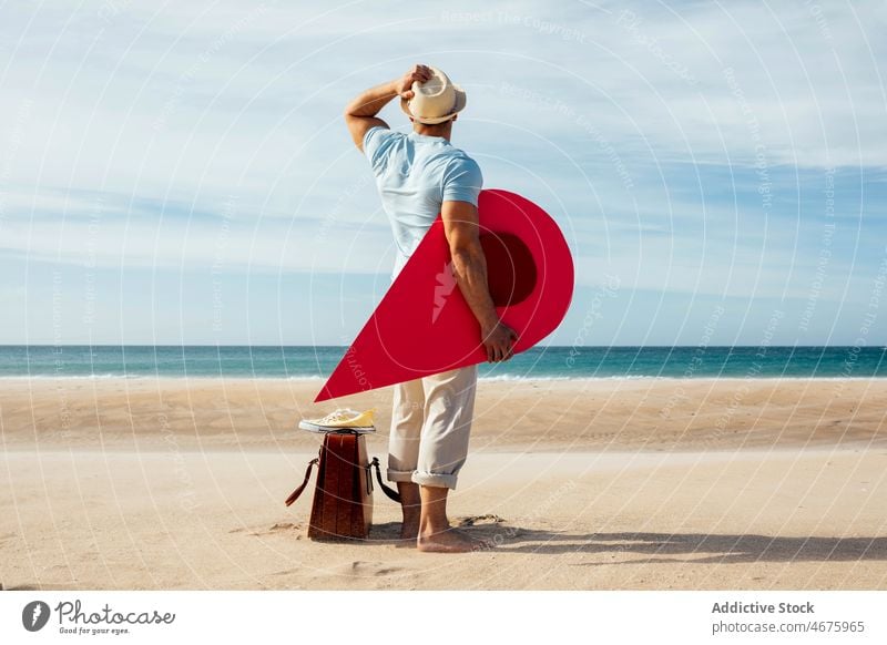 Traveling man with red map pointer on seashore pin lost location direction tourist beach traveler search tourism summer route adventure navigate destination guy