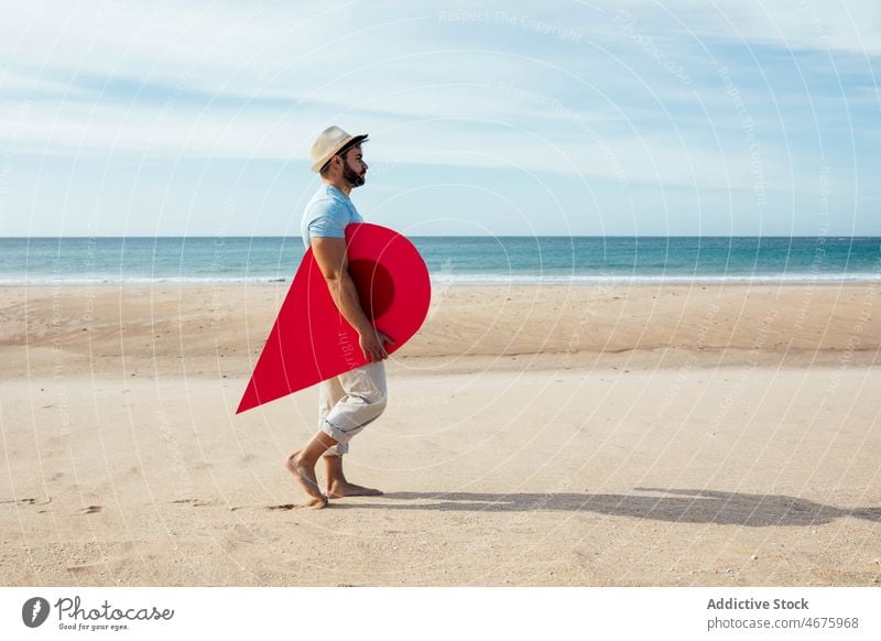 Man with red location pin walking along seashore man traveler map destination sign pointer beach male summer coast vacation journey navigate tourist trip