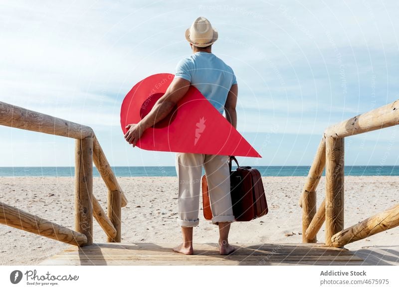 Traveling man with red map pointer on boardwalk pin lost location direction tourist beach traveler search tourism summer route adventure navigate destination