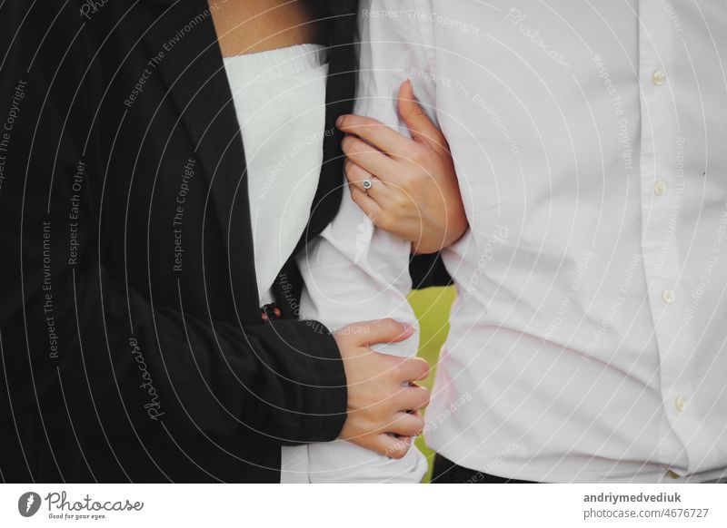 Hands together. Close-up of loving couple holding hands while walking outdoors. man friend husband support woman wife expressing love feelings, trust care honesty in relationship concept