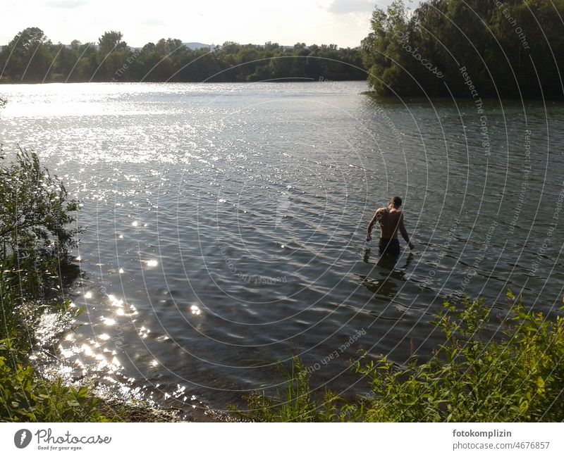 young man goes into lake Young man Boy (child) Lake be afloat bathe Swimming lake Swimming & Bathing Summer Water Vacation & Travel Man Youth (Young adults)