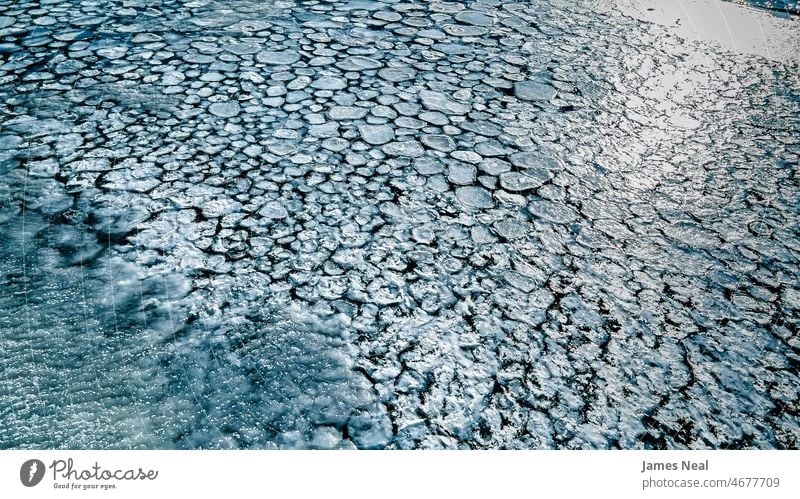 View of the icy patterns in the river sunny natural color nature water abstract lake glare snow textures wintry elevated photography temperature outdoors ice