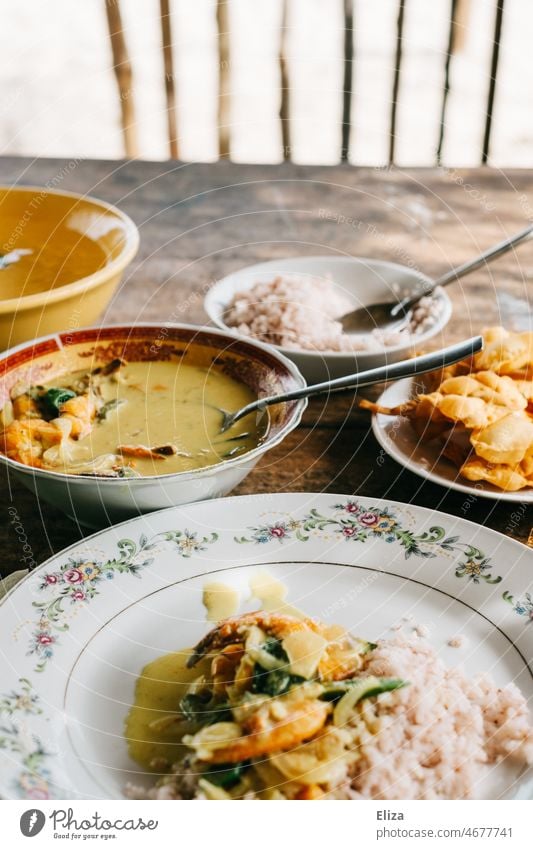 Yellow shrimp curry with rice and Sri Lankan papadams on a wooden table Curry powder Shrimps Rice Papadams Eating Delicious tart Wooden table bowl Meal Asian