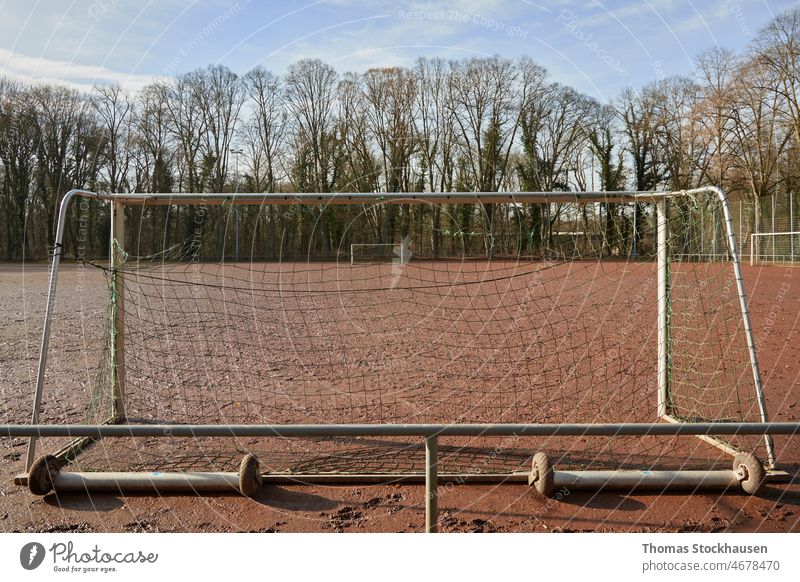 view through a goal to another on a cinder pith, red soccer field activity background club day exercise football football training horizontal net outdoor