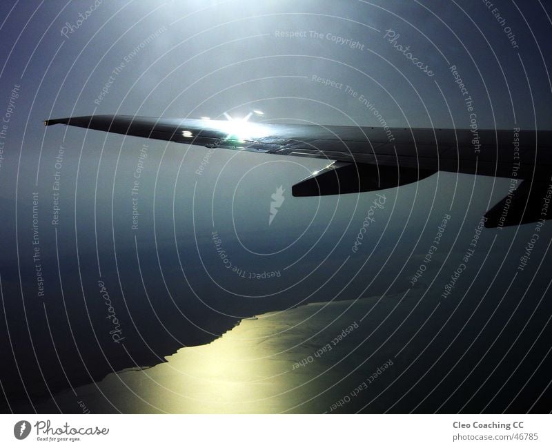 Through the airplane window Airplane Wing Dusk Reflection Vacation & Travel Clouds Egypt Speed Loud Gray Steel Dark Fog Exciting Grief Sunbeam Glittering Memory