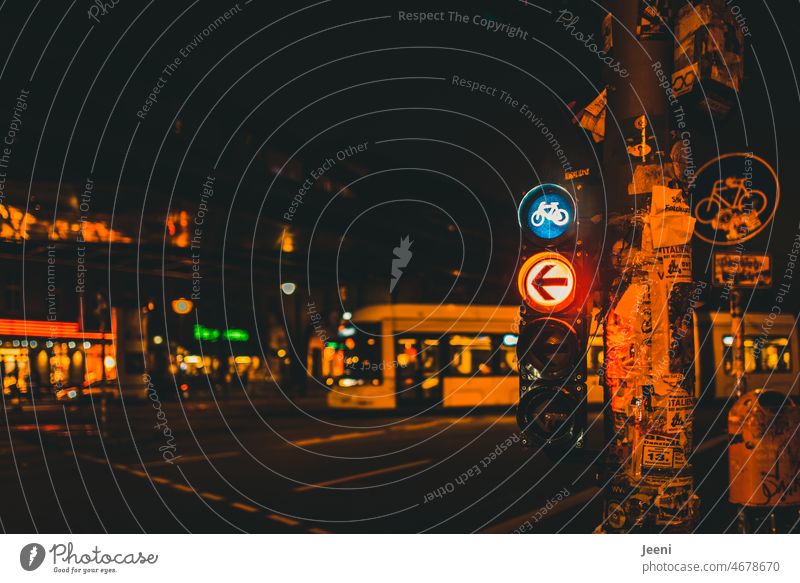 Streetcar passes and traffic light for bicycles shows red Tram Night Road traffic Light Town Traffic light Arrow Left Red Turn off Pictogram Transport Berlin