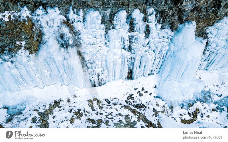 Frozen water on rock wall view natural winter nature high angle icy material cold frozen fall rocky waterfall waterfalls stone freezing temperature outdoors