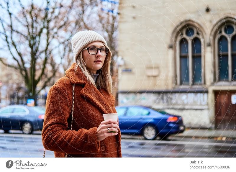 Woman at city street with coffee cup woman walking lifestyle eyeglasses urban crosswalk drink fashion business takeaway city life girl model road casual lady