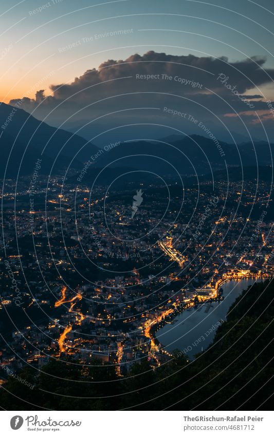 City at night with mountains in background clearer Town Lake Mountain Clouds Moody Lugano Hill Vantage point evening light