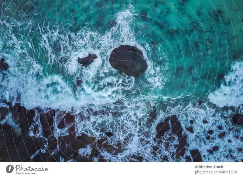 Ocean seashore with waves dashing against rocky cliffs water storm power crash splash motion ocean overcast coast stone seascape weather coastline nature