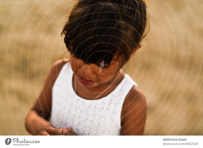 Sad Latin American girl on beach kid coast childhood sad upset unhappy shore frustrate cute sand summer adorable innocent recreation pretty resort