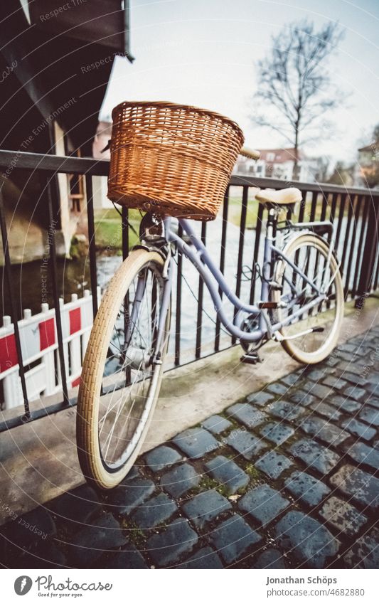 Lady's bicycle with basket stands at railing near Krämerbrücke bicycle basket Ladies' bicycle Bicycle Old town Erfurt Thuringia shopkeeper's bridge Stand