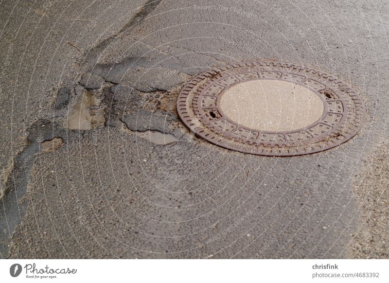 round manhole cover on rain wet road Channel Manhole cover Street Rain road damages Transport car Road traffic Car Means of transport Motoring