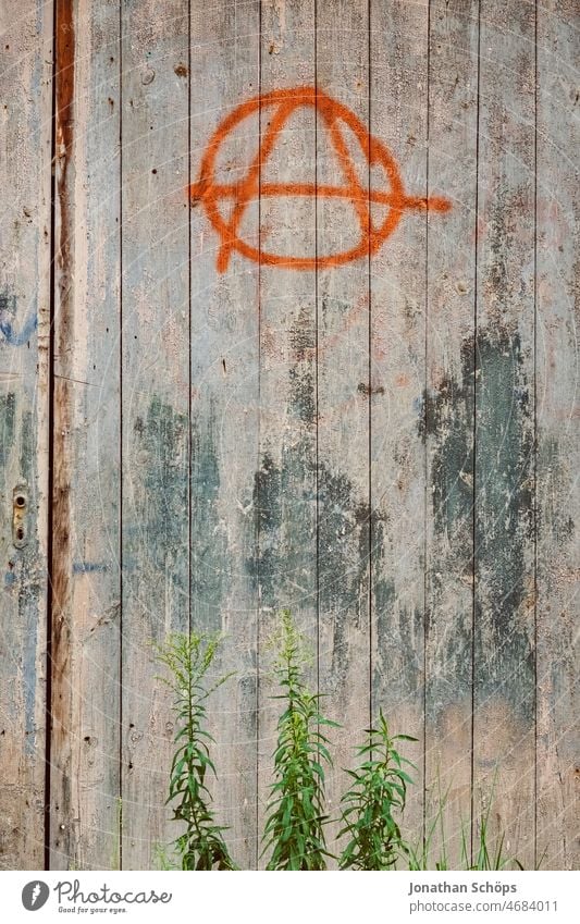 Anarchy symbol on wooden wall Anti-fascism Politics and state Left Chaos Graffiti Daub Political movements Punk Protest Resist Multicoloured Exterior shot