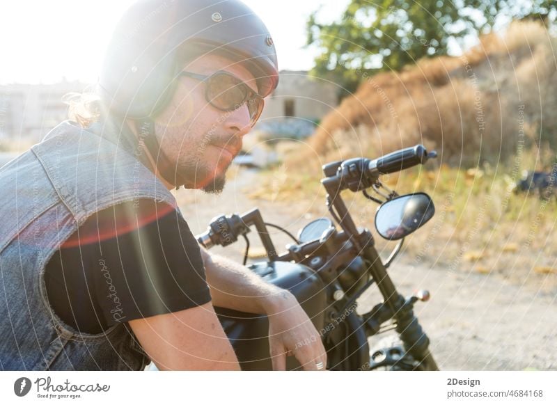 Young man wearing sunglasses on a chopper motorcycle ride transport transportation male person rider biker motorbike road travel vehicle urban adult classic