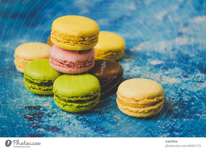 Variety of colorful macarons over a blue background macaroons gourmet food delicious sweet tasty delicatessen dessert cake bake bakery modern stylish food yelow