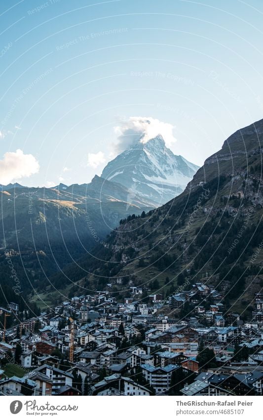 Zermatt with Matterhorn in the background Clouds Mountain Switzerland Tourism houses Village Snow Majestic mountains Peak Canton Wallis Landscape Landmark Rock