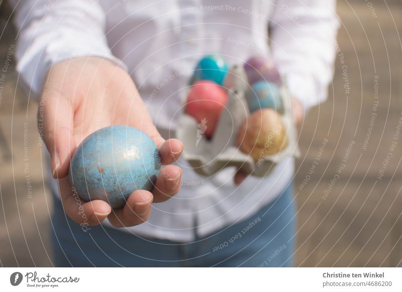 Colorful dyed Easter eggs in the hands of a young woman colored eggs give away Pattern egg colouring colorful eggs Tradition Feasts & Celebrations Decoration