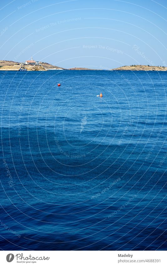 Blue water in summer with blue sky and sunshine in a bay in Foca on the Aegean Sea in Izmir province, Turkey Home country tourism Tourism Wanderlust holidays