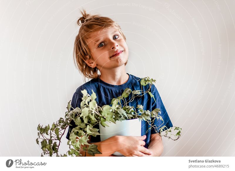 Cute blonde boy plant lover hand hold flower pot child kid gardening green happy nature holding lifestyle care little young person spring summer growth leaf