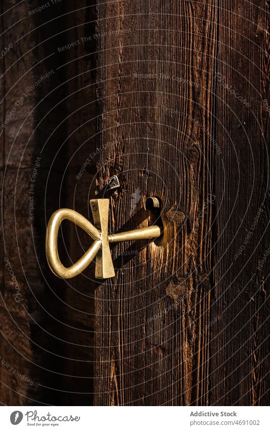 Key in lock of wooden door key shabby house building old weathered old fashioned vintage part fragment dwell element residential estate detail private aged