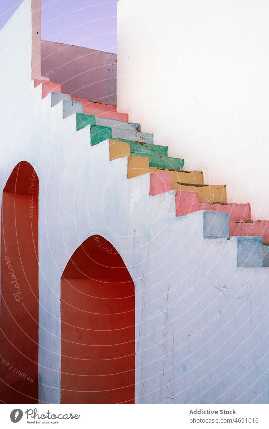 Shabby building with colorful stairs house stairway multicolored paint street shabby weathered step old city wall egypt local style obsolete property worn out