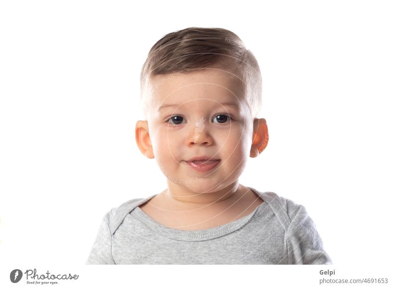 Little smiling baby in bodysuit sitting barefoot on the floor child person white cute adorable toddler infant boy happy isolated little portrait childhood small