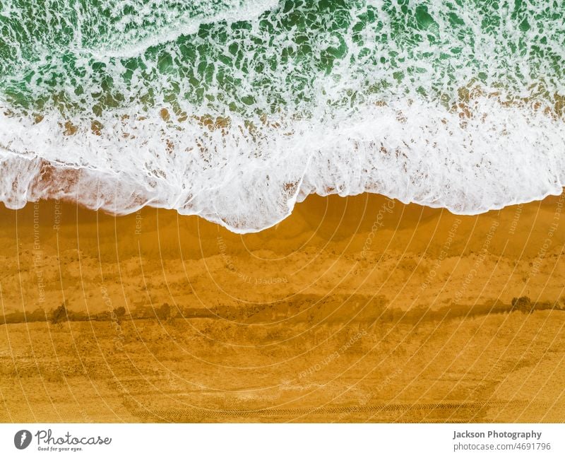 Top view of waves crushing on sandy beach in Albufeira, Algarve, Portugal albufeira ocean nature copy space vibrant outdoor nature background algarve portugal