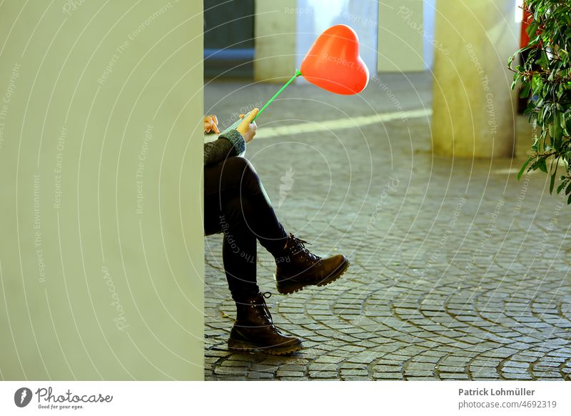 matter close to the heart Heart Love Wait In love Red symbol Woman balloon person Street date wartemd Legs Connection Manmade structures Germany by oneself