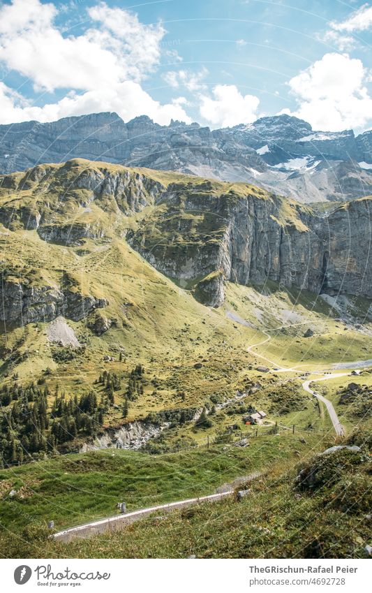 Road in front of mountains Uri soil Street pass road alpine pass Meadow Wall of rock Mountain Forest Clouds Alps Nature Exterior shot Rock