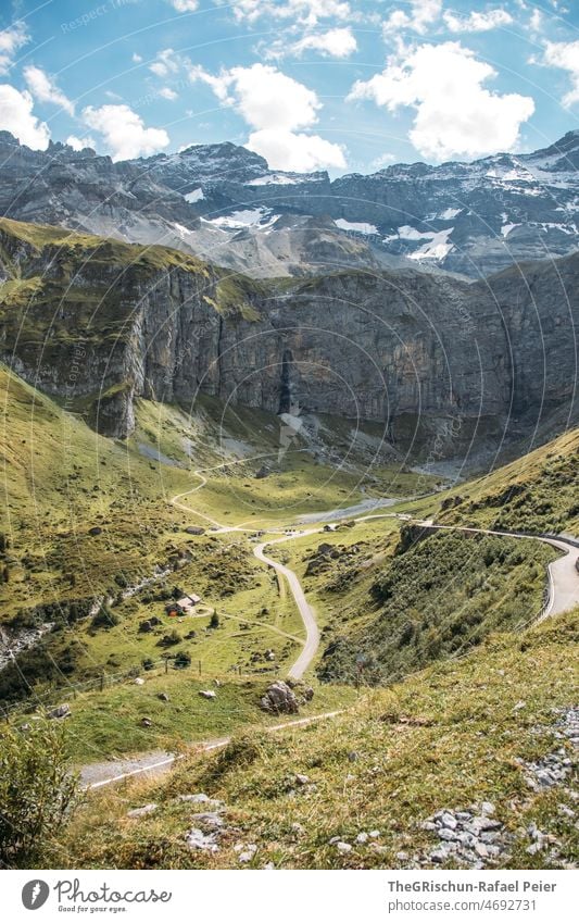 Road in front of mountains Uri soil Street pass road alpine pass Meadow Wall of rock Mountain Forest Clouds Alps Nature Exterior shot Rock