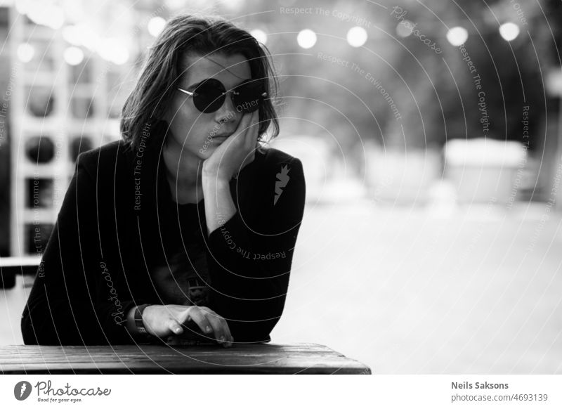 waiting for waitress young human glasses black glasses black suit Person wearing glasses festival outdoor food restaurant table hand thinking