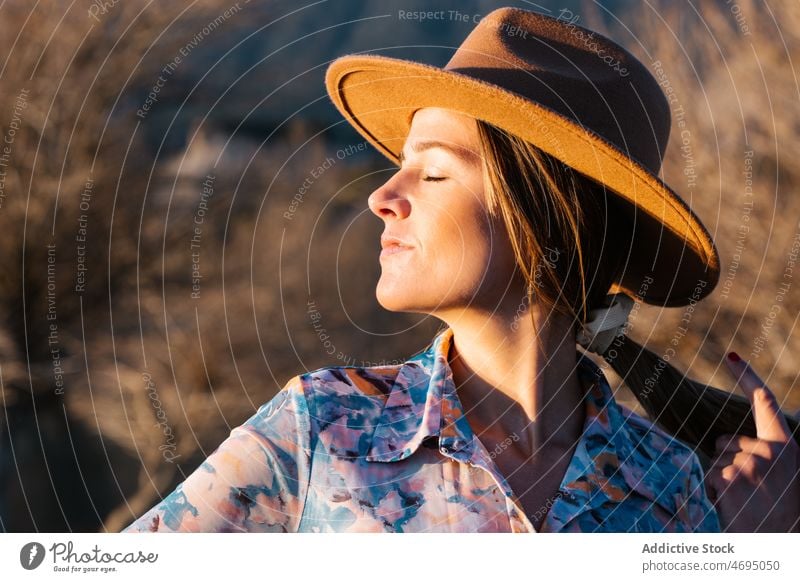 Woman in ht standing in countryside woman style nature sunlight feminine hat enjoy appearance rural female headwear headdress dreamy outfit apparel charming